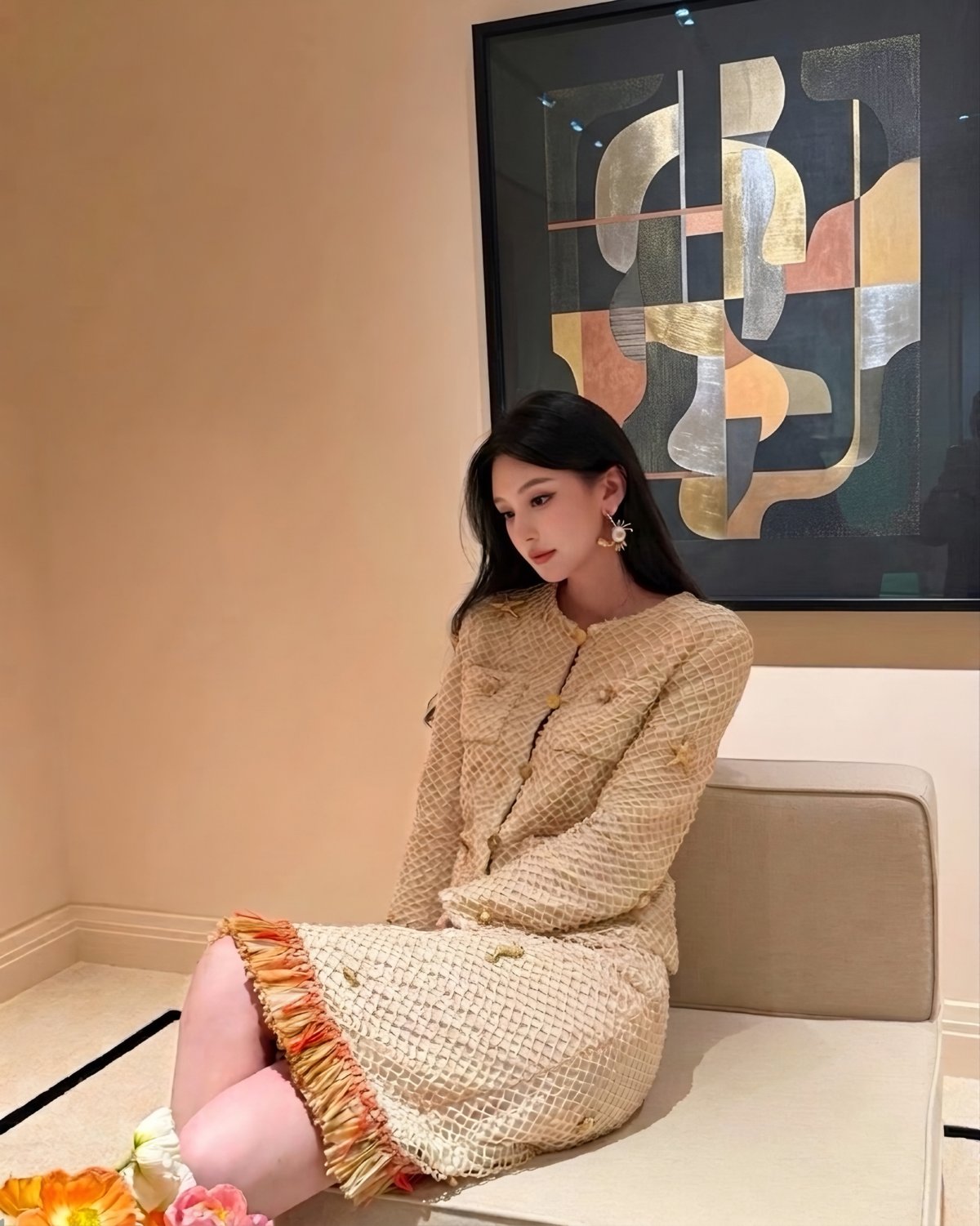 Model wearing a cream tweed jacket and skirt